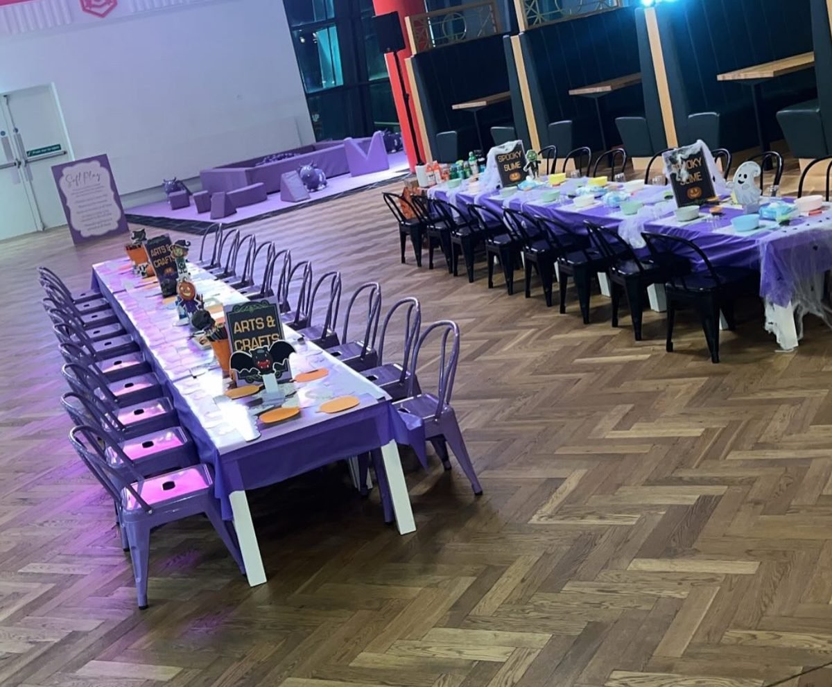 A large-scale Jazzy Slime event set up across multiple tables at a big venue