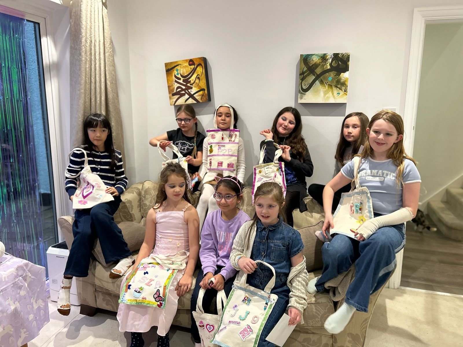Kids proudly holding their finished creations