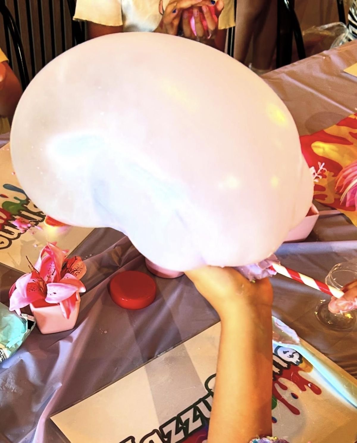 A gigantic stretchy slime bubble held up at a Jazzy Slime Ultimate Party